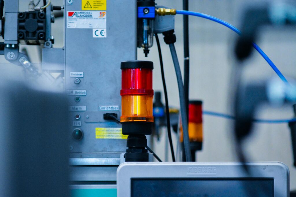 Detailed view of automated machinery with warning signals in an industrial setting.