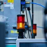 Detailed view of automated machinery with warning signals in an industrial setting.